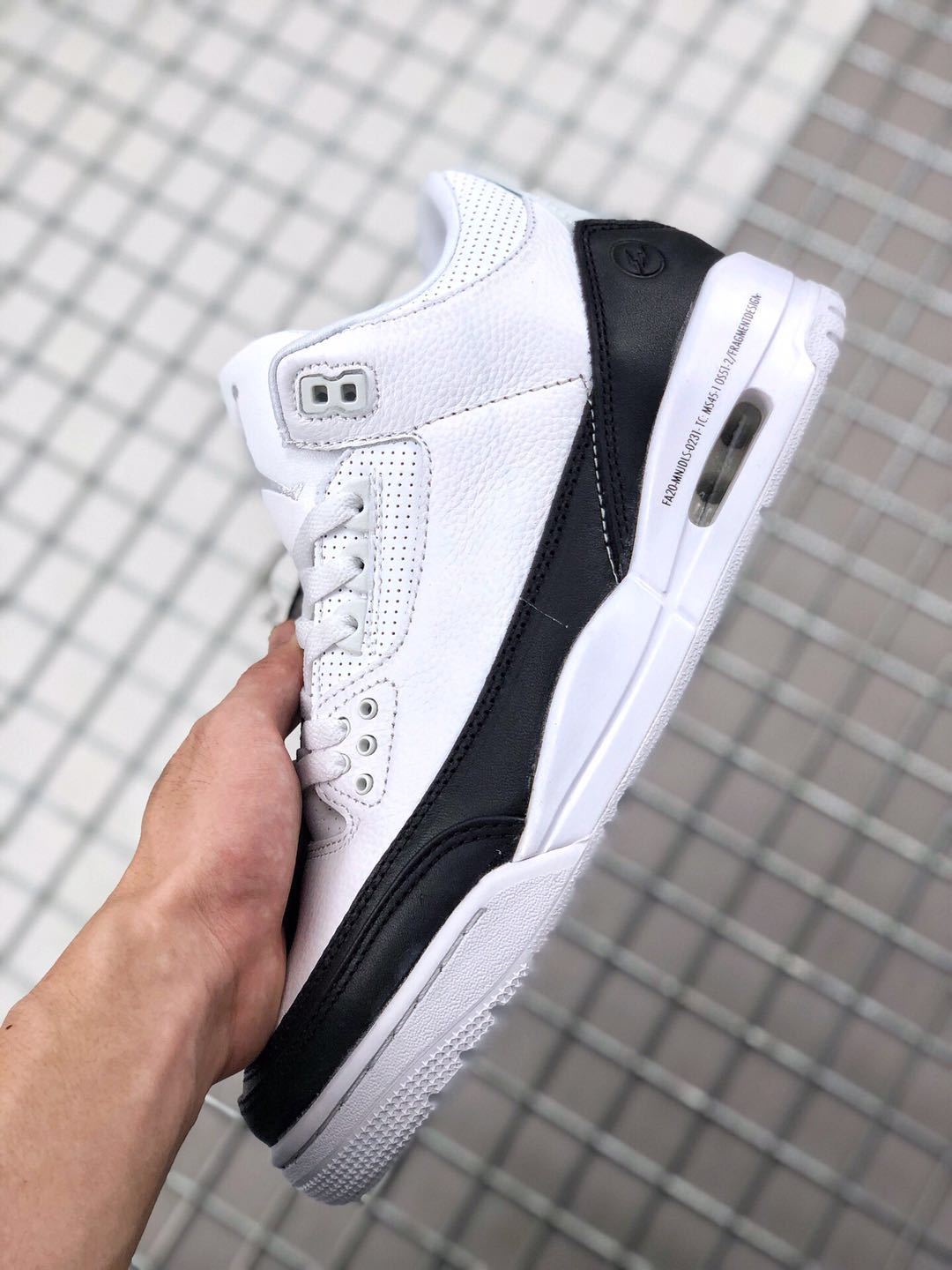 Side profile showing the black heel and forefoot overlays with a visible air window.