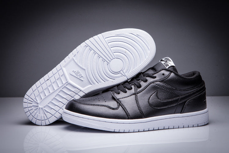 Black low-top Jordan sneakers showing the white outsole tread and side profile.
