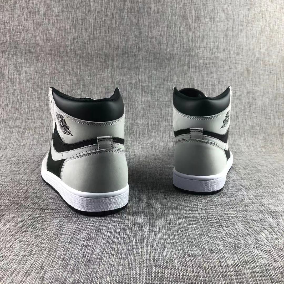 Rear view showing the black and grey heel panels and white midsoles.