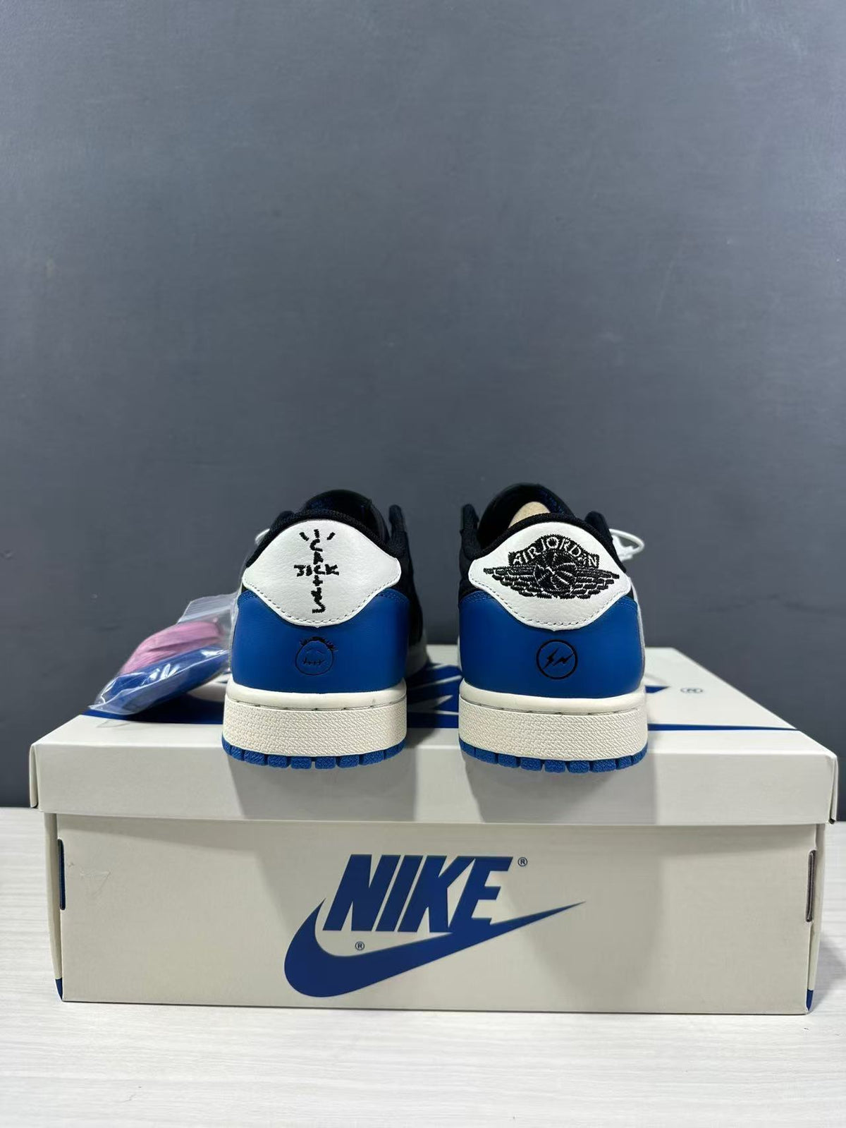 Rear view showing blue heel panels, white heel tabs, and contrasting heel graphics.