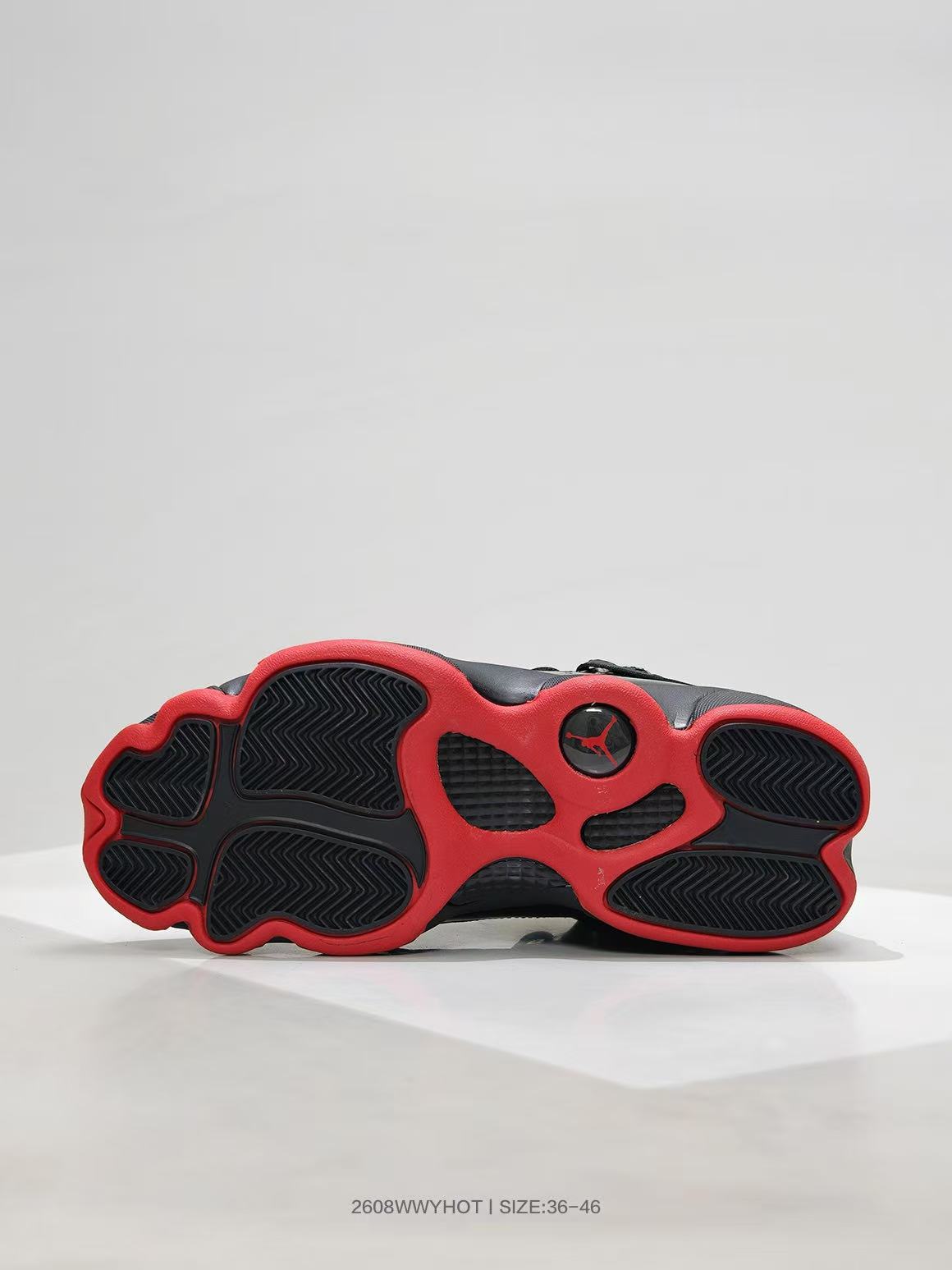 Outsole view showing the black and red traction pattern.