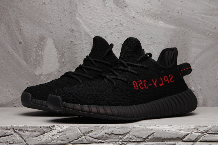 Side-by-side view of black lace-up sneakers with red side lettering.