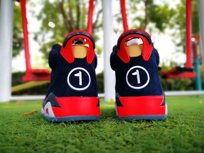Rear view of the pair showing red heel panels and white circular heel branding.
