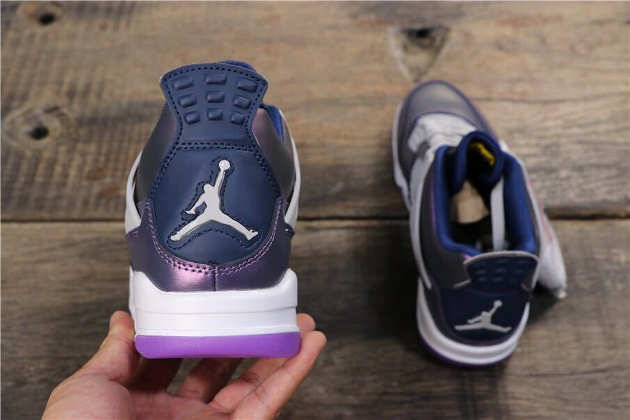 Rear view showing the Jordan heel logo, dark blue heel section, white midsole, and purple outsole.