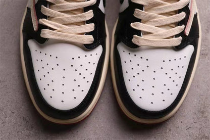 Close-up of the perforated white toe boxes framed by black overlays.