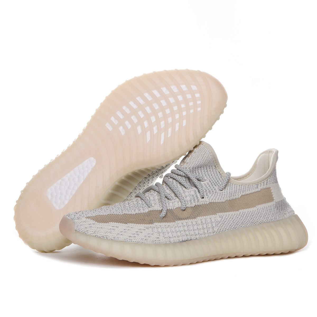Side view of cream and gray sneakers showing the outsole pattern, laces, side stripe, and ribbed sole.