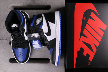 Black, white and blue high-top sneakers displayed beside a shoebox and spare blue laces.