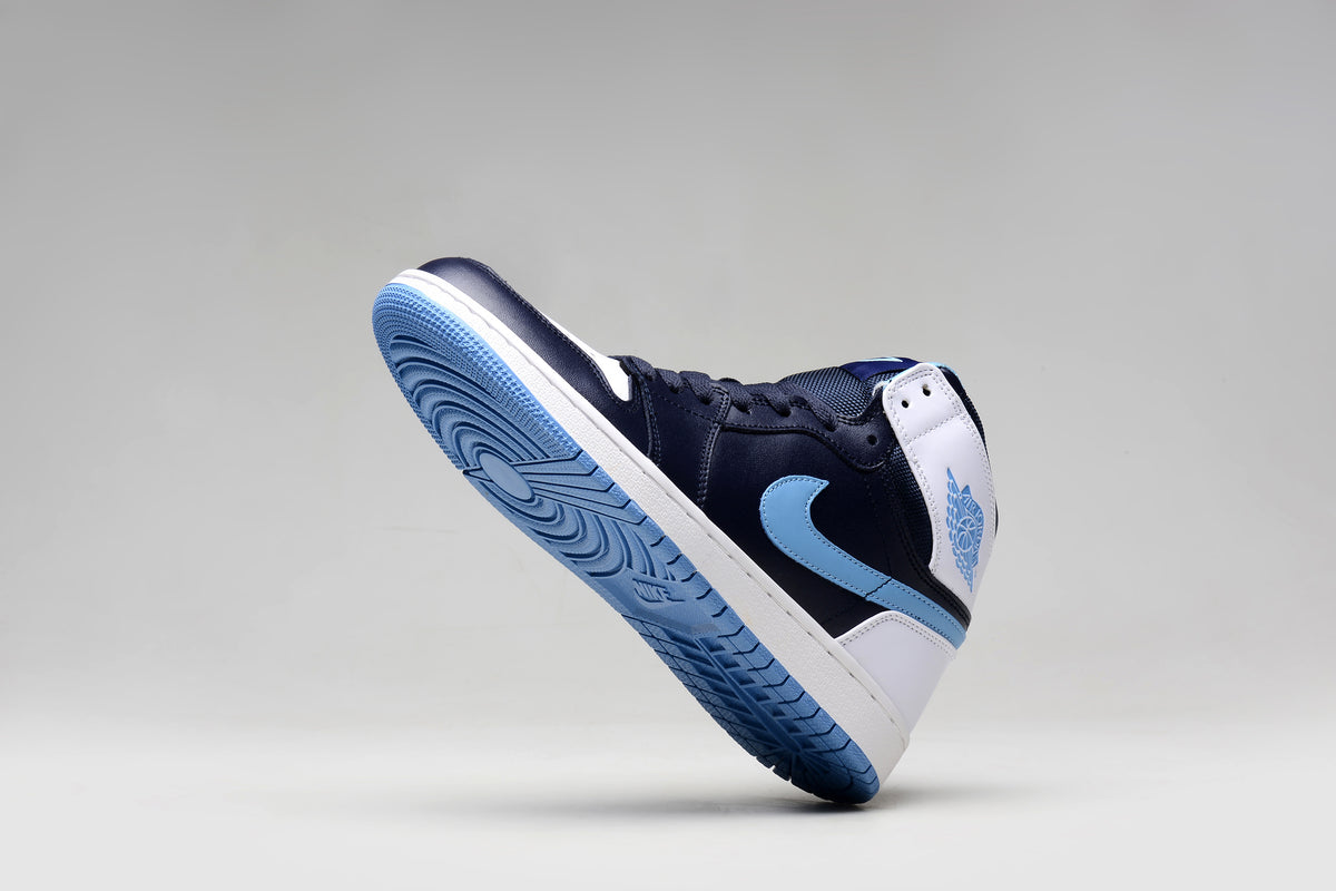 Jordan 1 Retro sneaker showing the navy upper, light blue outsole, and white heel panels