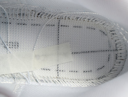 Close-up of the white textured sneaker interior and stitched lining.