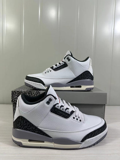 Angled product view of the white and grey Air Jordan 3 sneakers with one shoe in the foreground.