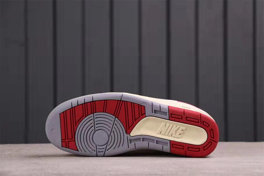 Outsole view showing red and gray traction sections with a central Nike marking.