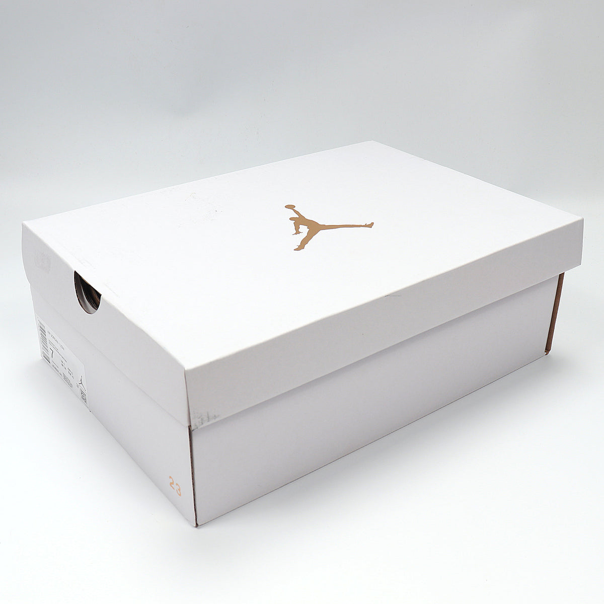 White Jordan shoebox with a gold Jumpman logo.