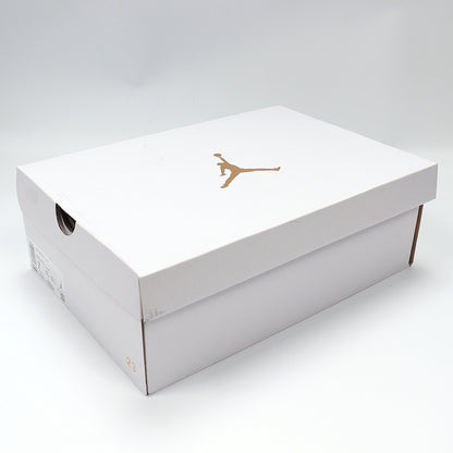 White Jordan shoebox with a gold Jumpman logo.