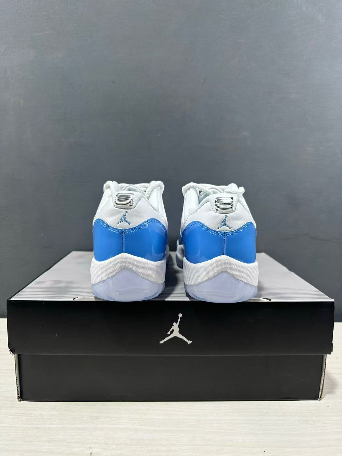 Rear view of the pair showing blue heel panels, white collars, and Jordan branding.