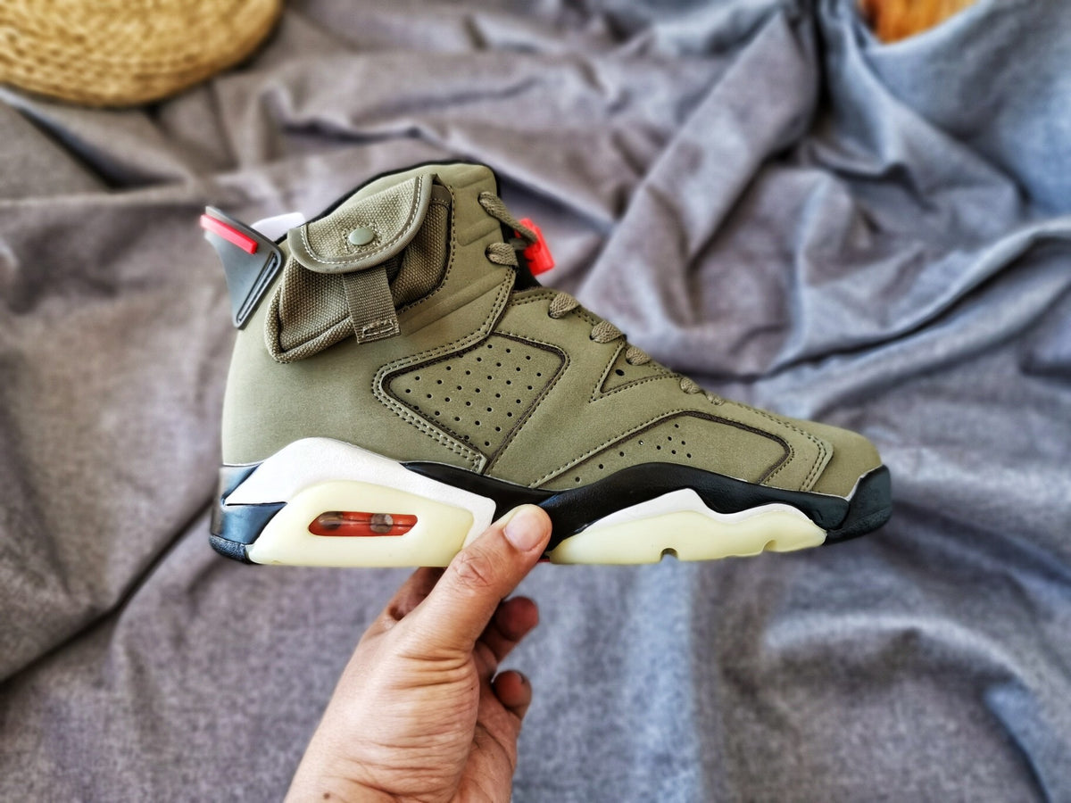 Outer side profile of the olive high-top sneaker with layered panels and visible heel cushioning detail.