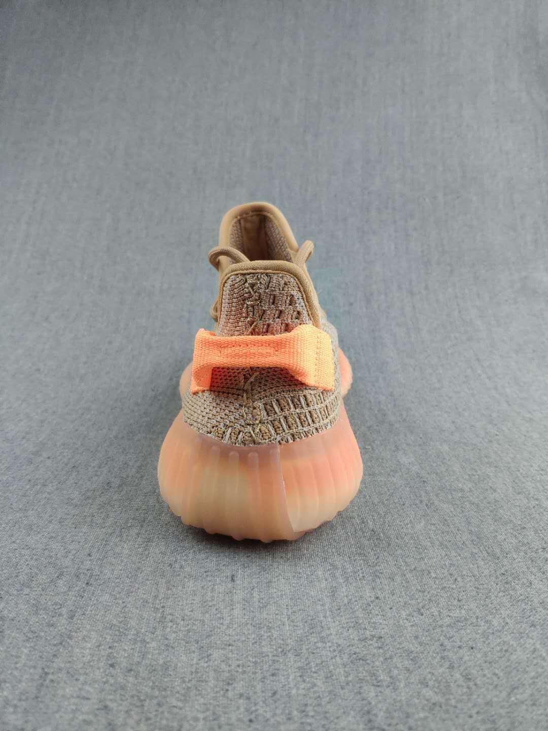 Rear view highlighting the orange heel bands and translucent amber-toned sole.