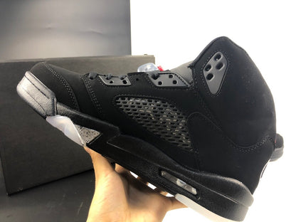 Side profile showing the black upper, gray mesh panel, translucent outsole section, and midsole window.