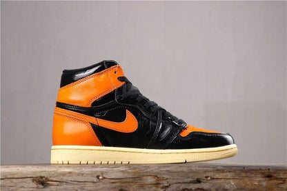 Side profile of a single black and orange high-top sneaker with an orange Swoosh and cream-colored outsole.
