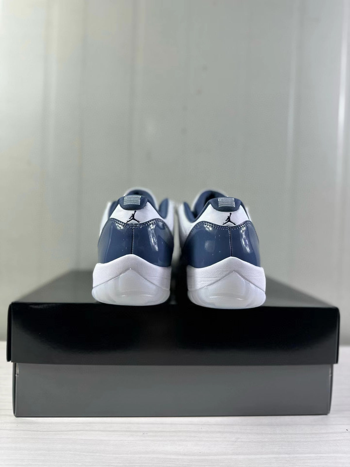 Rear view of the white and blue Jordan Air Jordan 11 Low sneakers