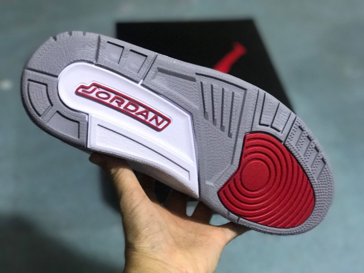 Outsole of a Jordan 3 Retro sneaker in gray, white, and red