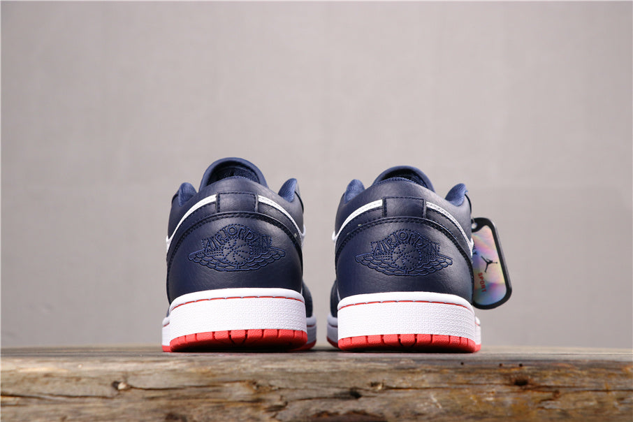 Rear view of the pair showing dark blue heel panels, embossed winged branding, white midsole, and red outsoles.