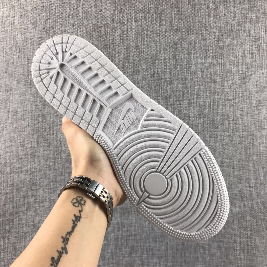 Underside view of the white outsole and circular tread details.