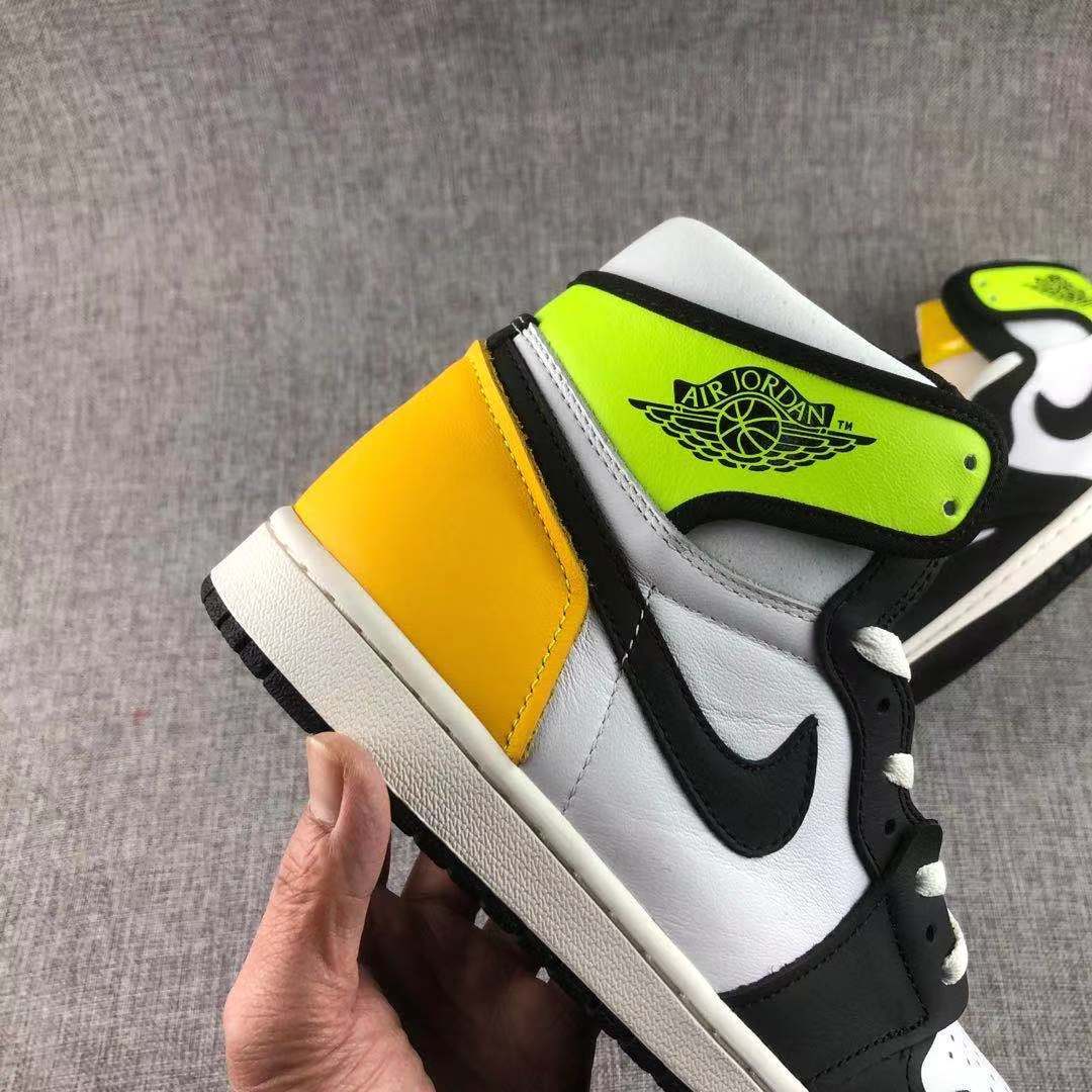 Angled side view highlighting the black Swoosh, white side panel and yellow-gold heel.