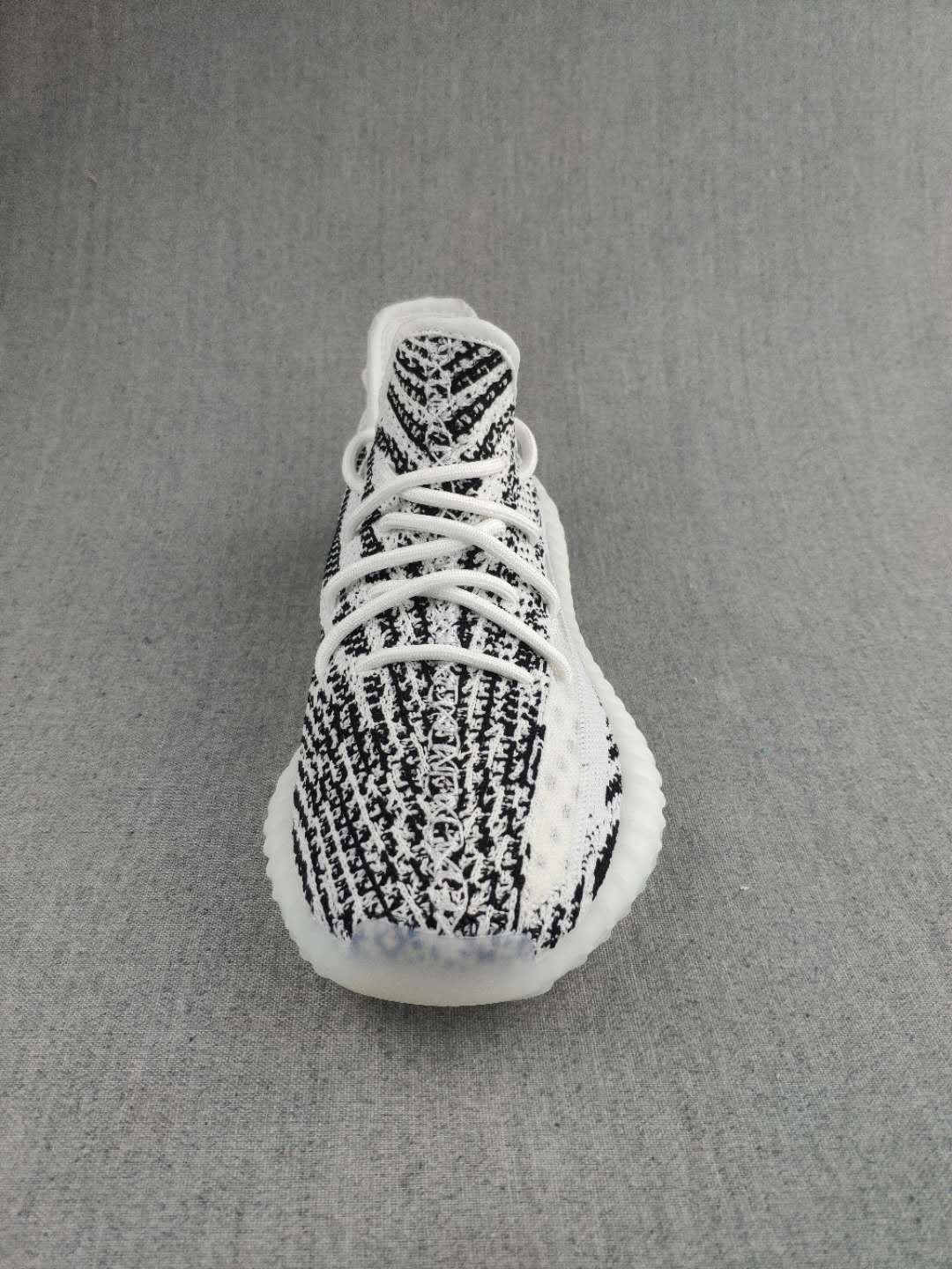 Top view showing the patterned knit toe box, tongue, and white lacing.