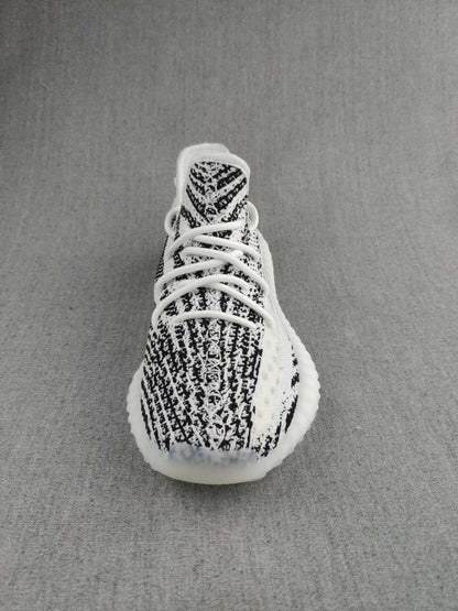 Top view showing the patterned knit toe box, tongue, and white lacing.