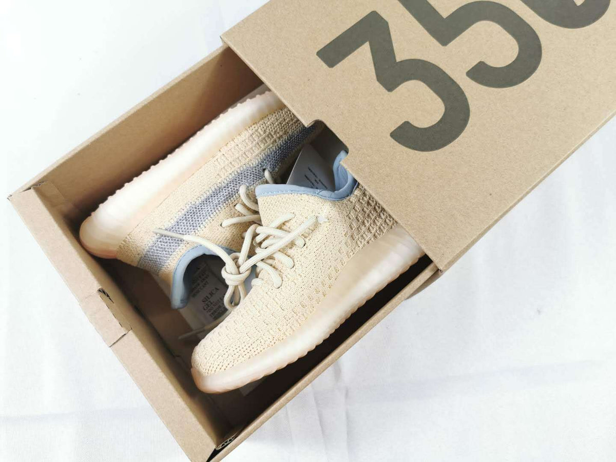 Pair of sneakers presented inside a box marked 350.