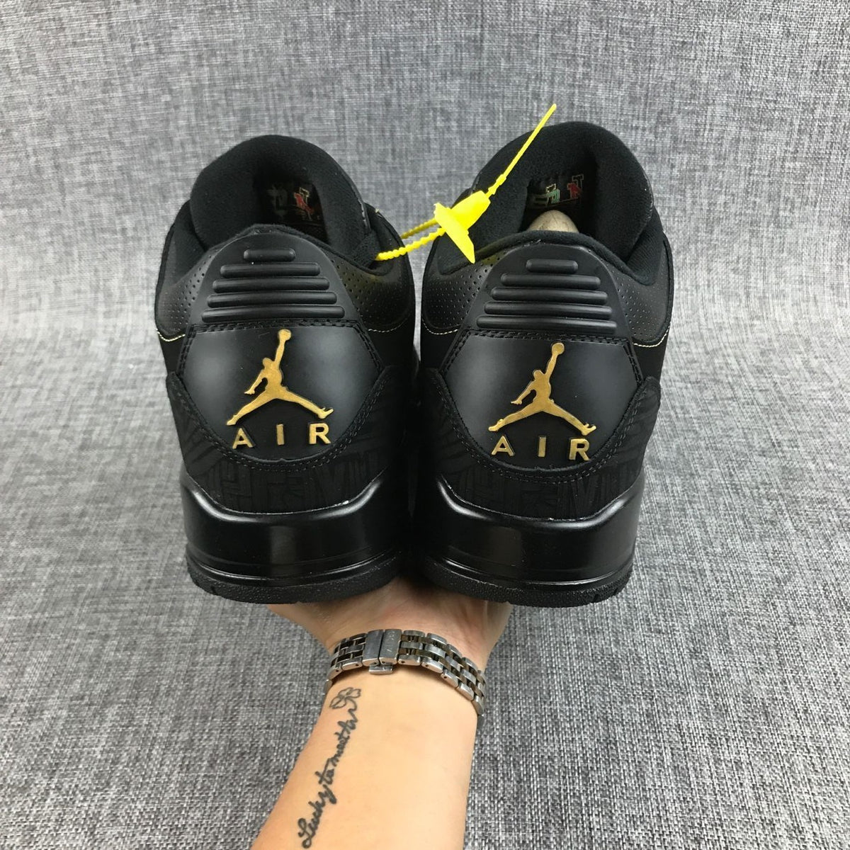 Back view of the pair with gold-colored heel logos