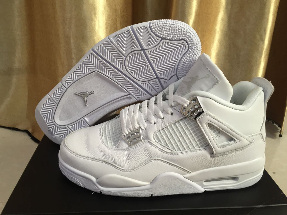 White Jordan 4 sneaker photographed with its patterned outsole facing upward beside the matching shoe.