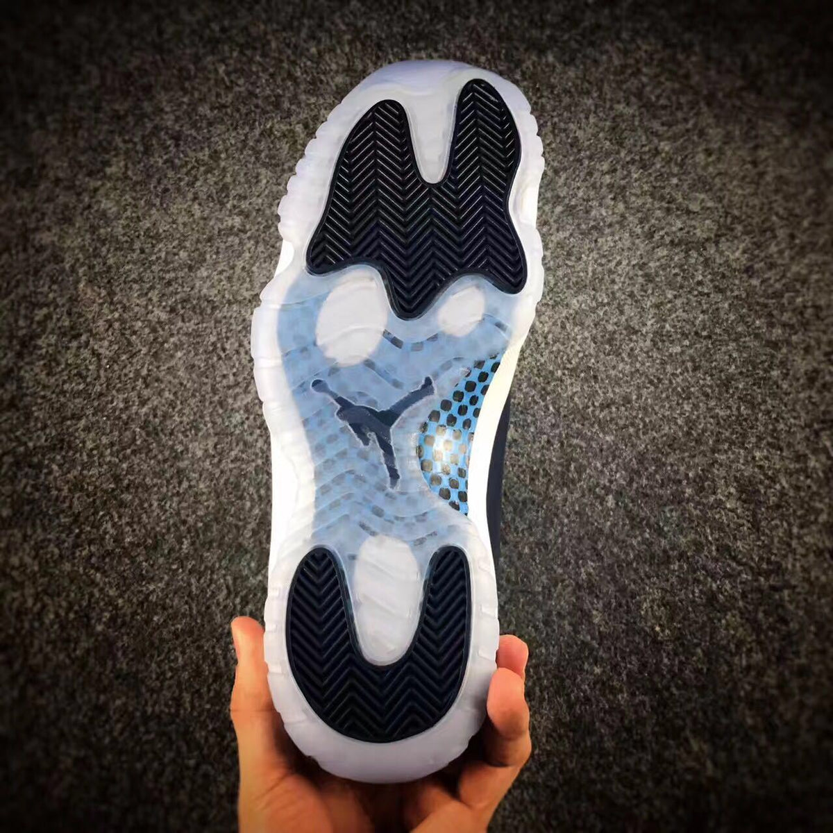 Underside view showing the translucent outsole, dark traction sections, and central Jumpman detail.