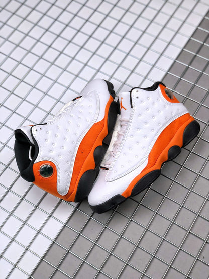 Pair of white, orange, and black Air Jordan 13 sneakers