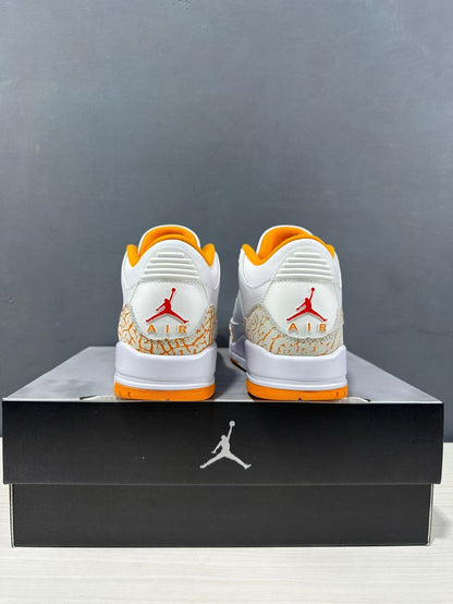 Rear view of the pair showing red Jordan branding, orange heel lining and outsole accents, and elephant-print heel panels.
