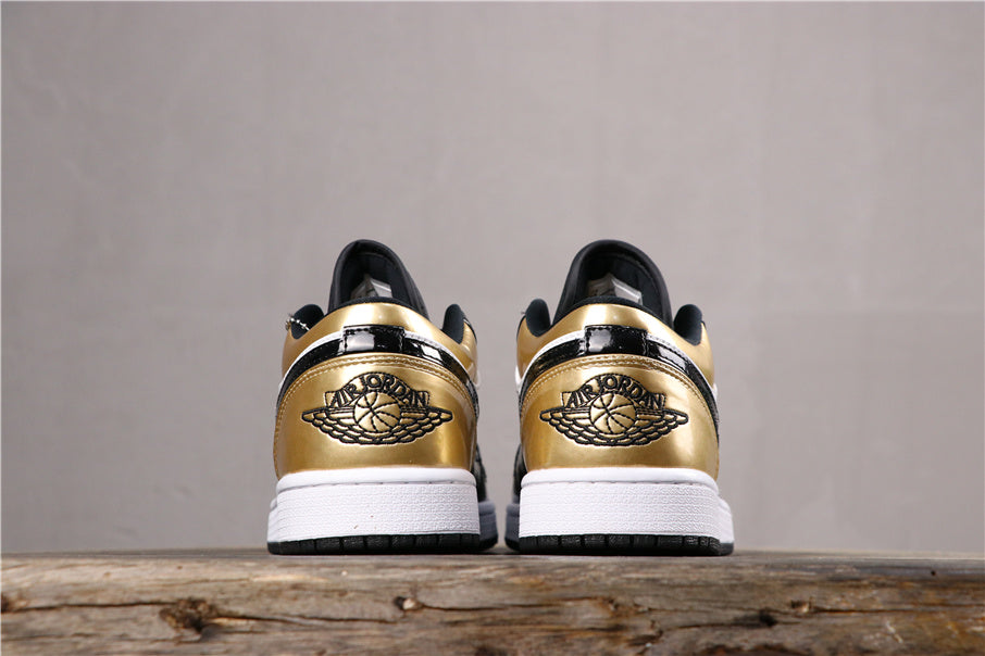 Rear pair view showing matching metallic gold heel panels, Jordan Wings branding, white midsoles, and black outsoles.