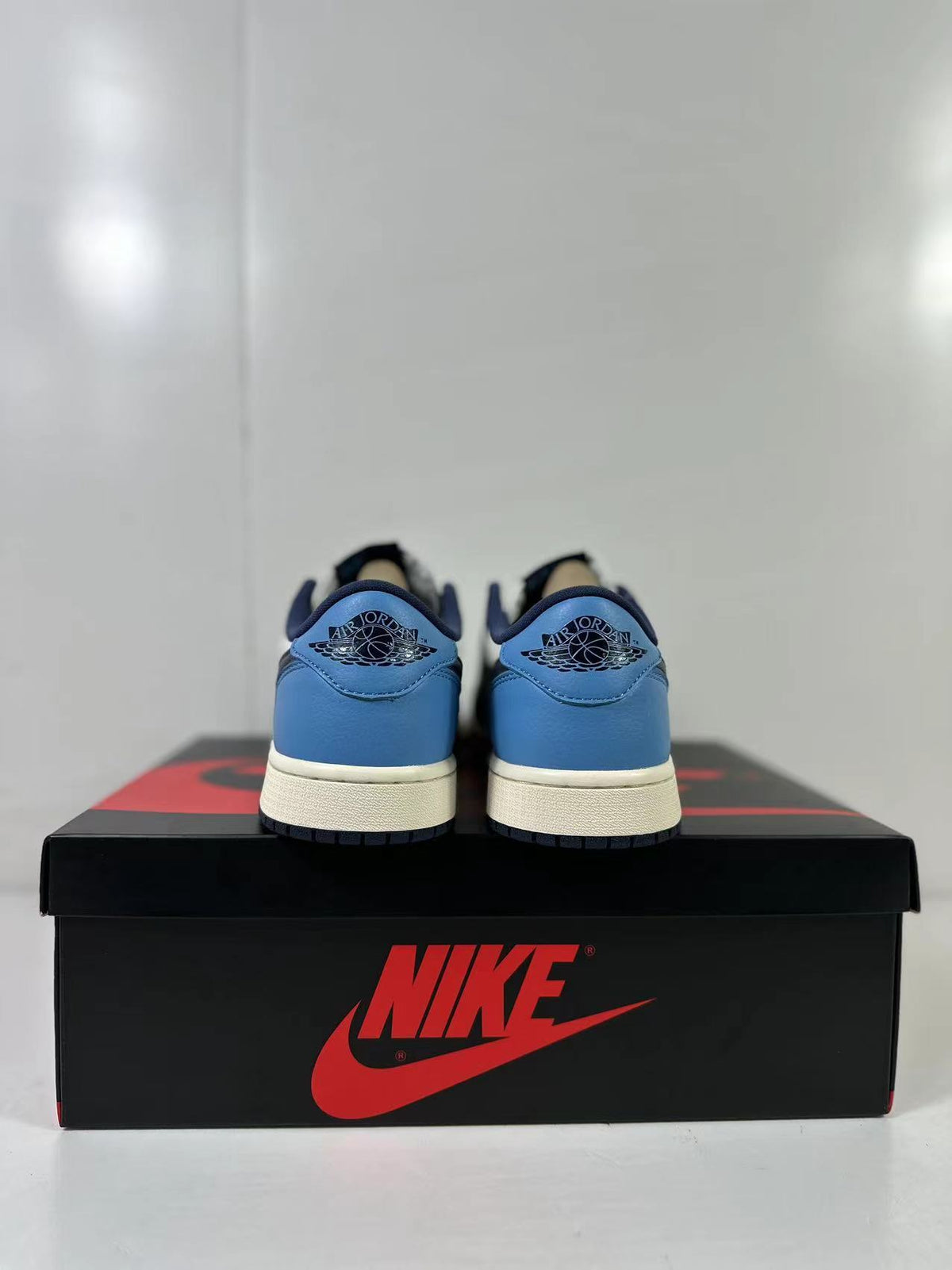 Rear view of the pair showing blue heel panels and Jordan wing details.