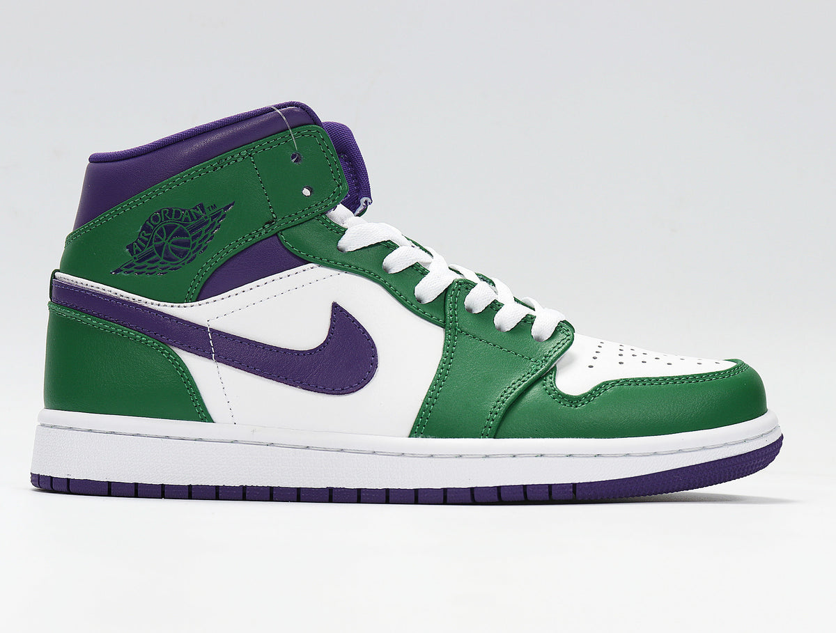 Side profile of a green, white and purple high-top sneaker showing the Jordan Wings logo and purple Swoosh.