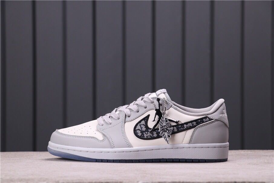 Side profile showing the patterned Swoosh and attached metallic lace accessory.