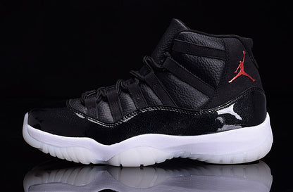 Side profile of a black high-top sneaker with red heel branding, glossy black paneling, and a white translucent outsole.