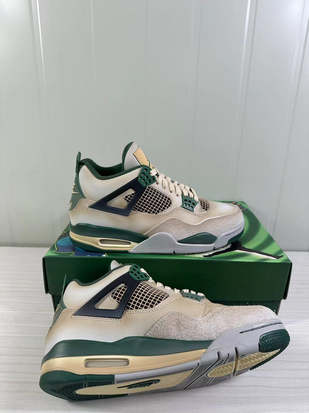 Air Jordan 4 Retro sneakers shown from side and underside angles, highlighting the mesh panels, midsole and outsole.