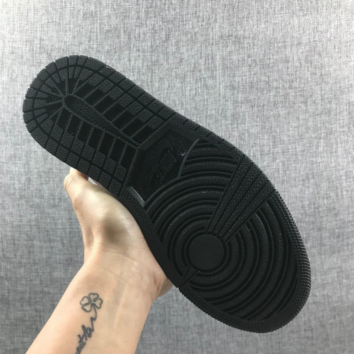 Close view of the black rubber outsole with its circular traction pattern.
