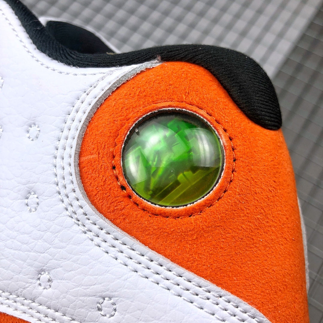 Close-up of the circular green detail set into the orange heel panel