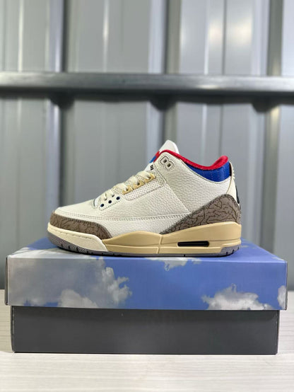 Side profile highlighting the patterned heel overlay, blue-and-red collar, and neutral-toned midsole.
