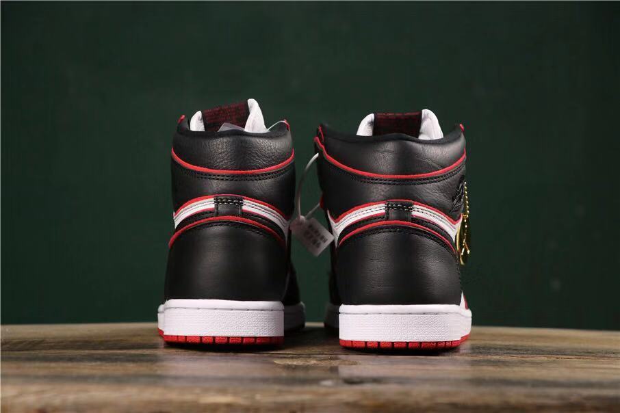 Rear view of the pair showing black heel panels, red trim, white accents, and white midsoles.