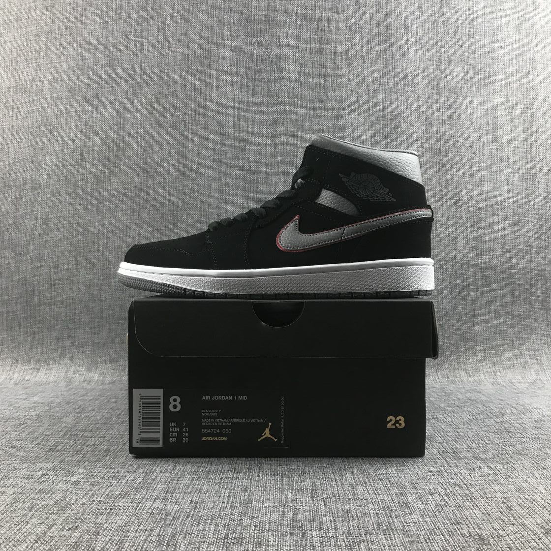 Air Jordan 1 Mid sneaker displayed on its box; the box shows EUR 41, UK 7, style code 554724 060 and black, grey and white color text.
