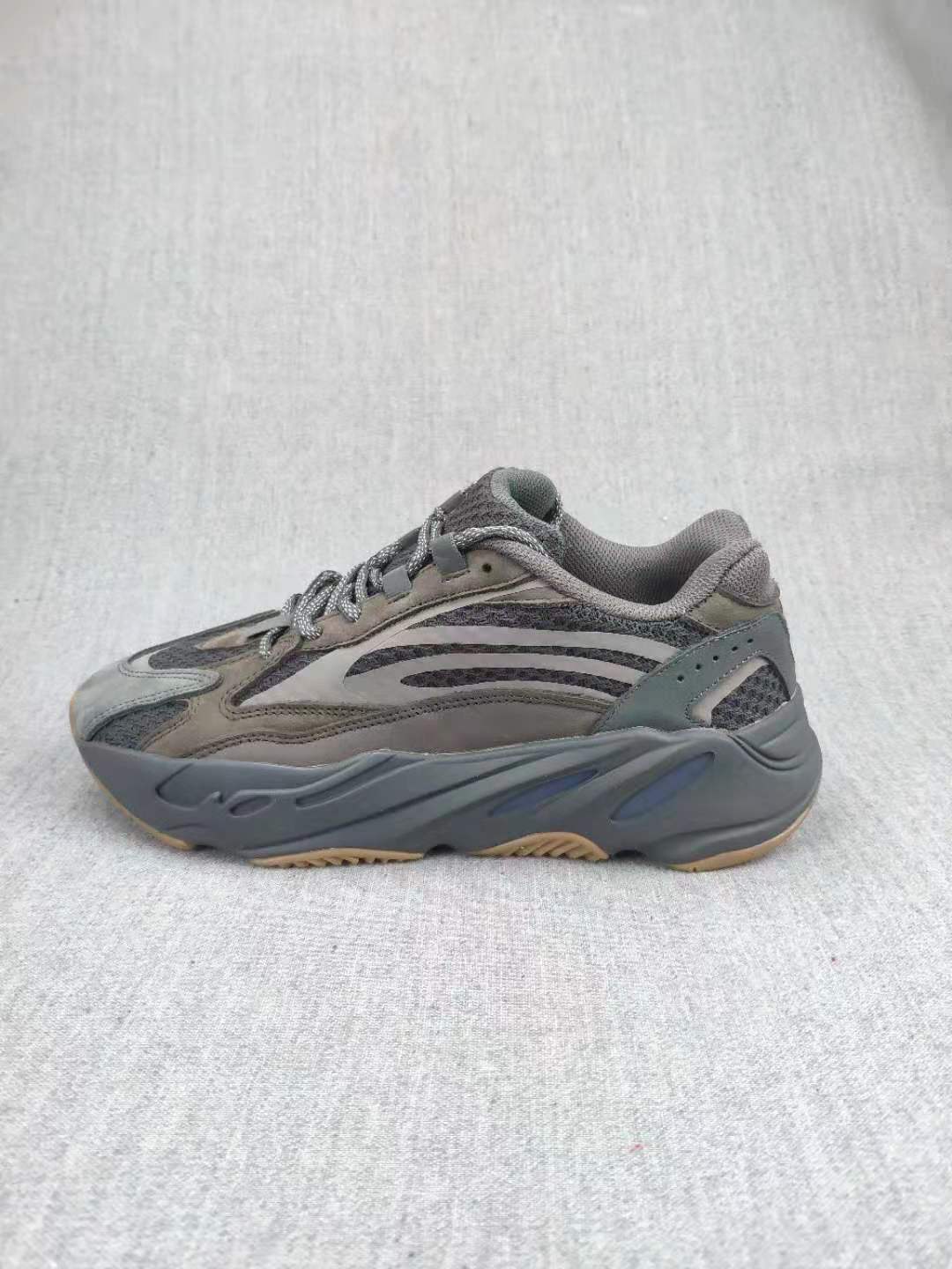 Side profile of the gray sneaker showing the panel construction and sculpted sole.