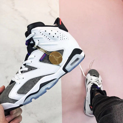 Angled front-side view highlighting the white laces, grey overlays, purple tongue detail, and translucent outsole.
