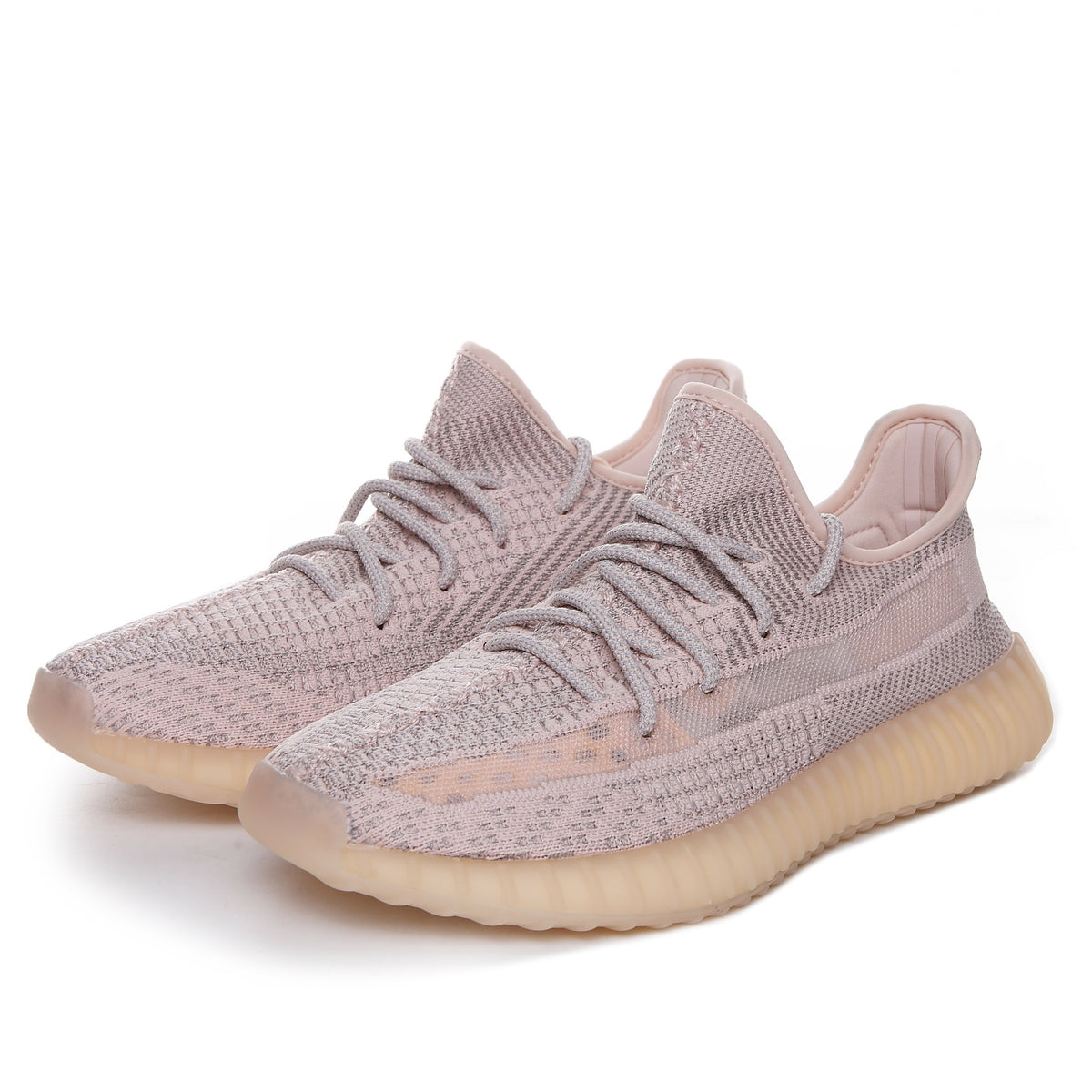Three-quarter view of a pair of taupe-pink knit low-top sneakers with tonal detailing.