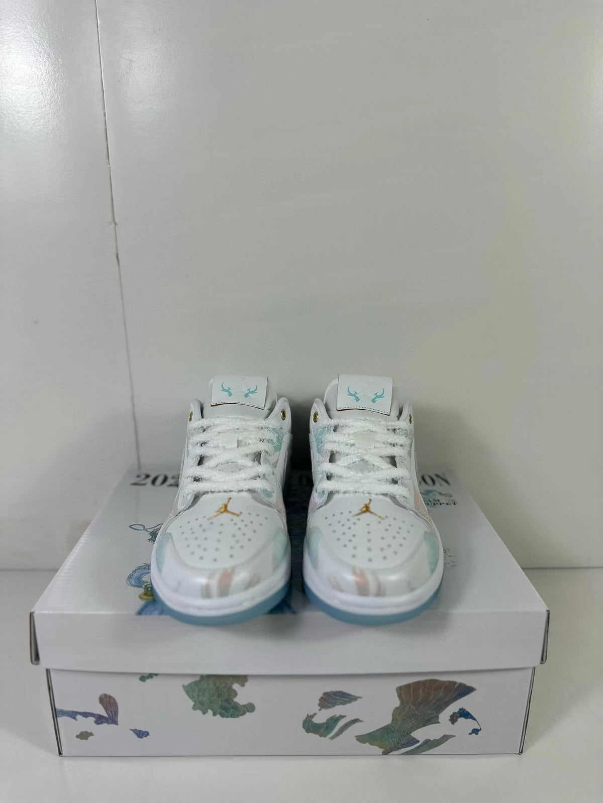 Front view showing the perforated toe boxes, white laces, and pastel detailing.
